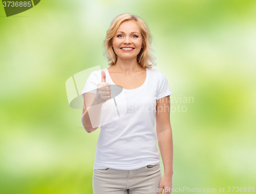 Image of smiling woman in white t-shirt showing thumbs up