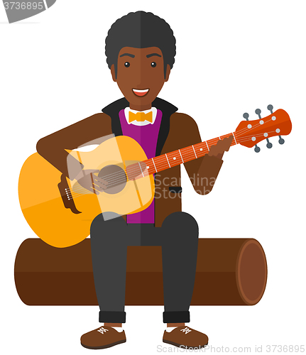 Image of Man playing guitar.