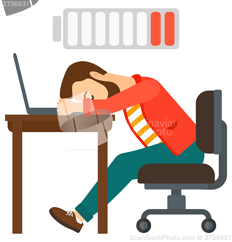 Image of Man sleeping at workplace.