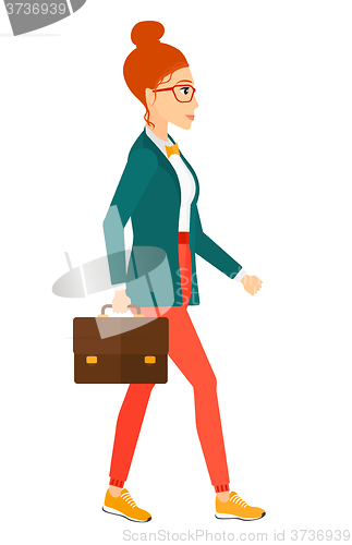 Image of Business woman walking with briefcase. 