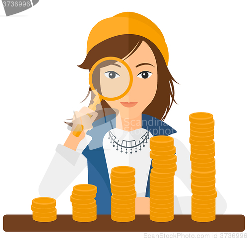 Image of Woman with magnifier and golden coins. 