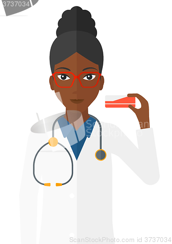 Image of Pharmacist showing some medicine.