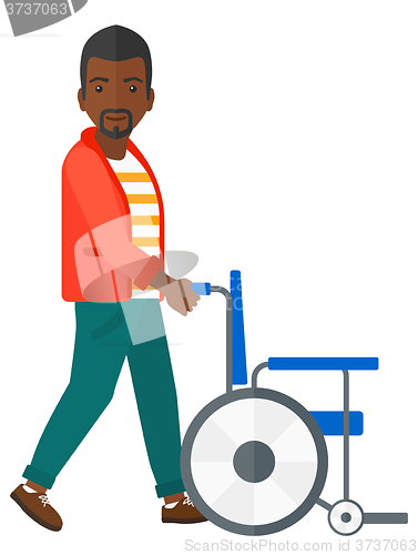 Image of Man pushing wheelchair.