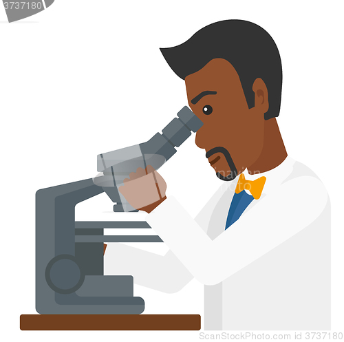 Image of Laboratory assistant with microscope.