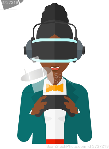 Image of Woman in oculus rift and console in hands.