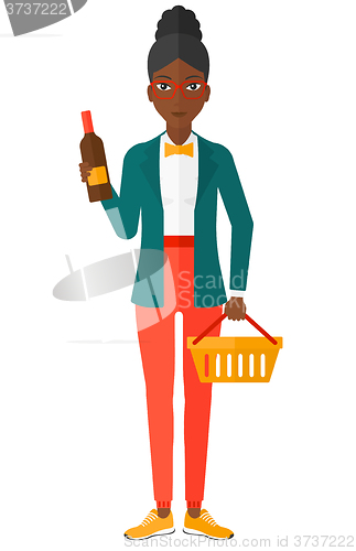 Image of Customer with shopping basket and bottle of wine.