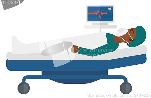 Image of Patient lying in bed with heart monitor.