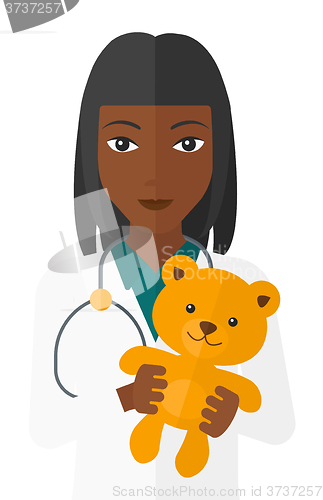 Image of Pediatrician holding teddy bear.