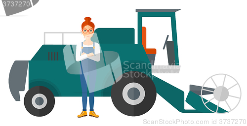 Image of Woman standing with combine on background.