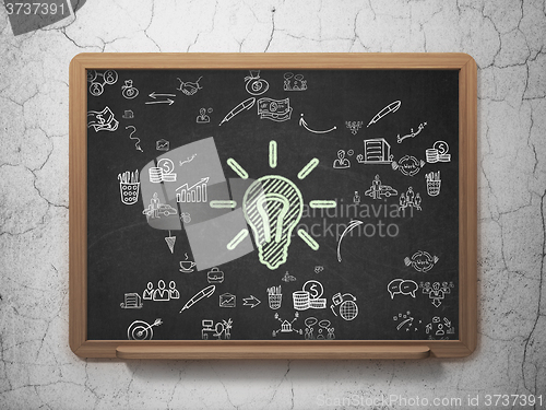 Image of Business concept: Light Bulb on School Board background