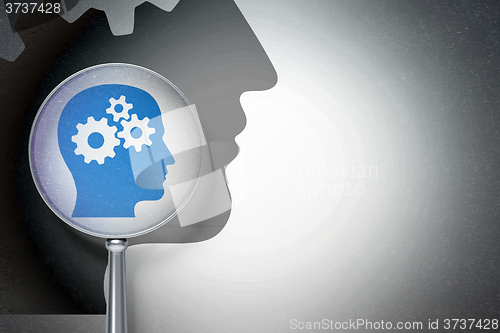 Image of Education concept:  Head With Gears with optical glass on digital background