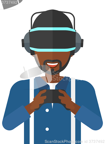 Image of Man in oculus rift and console in hands.