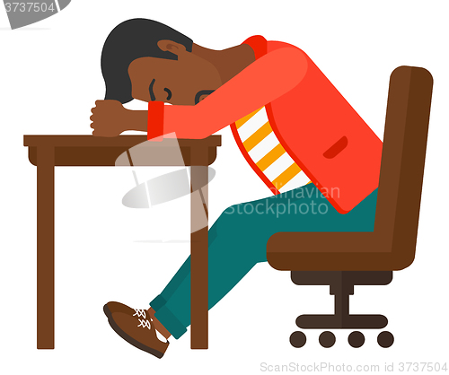 Image of Man sleeping on table.