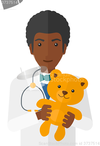 Image of Pediatrician holding teddy bear.