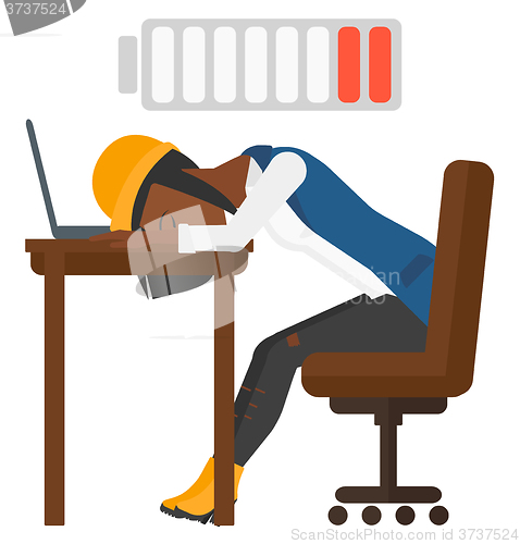 Image of Man sleeping at workplace.