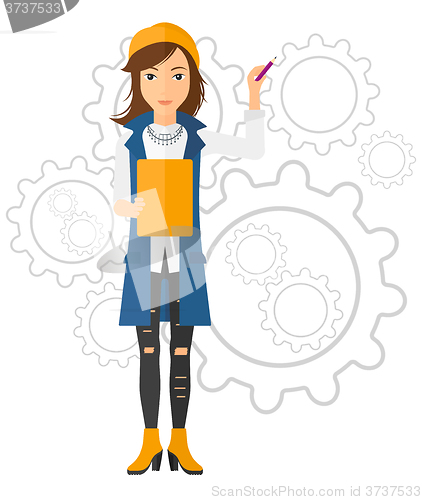 Image of Woman standing on gears background.