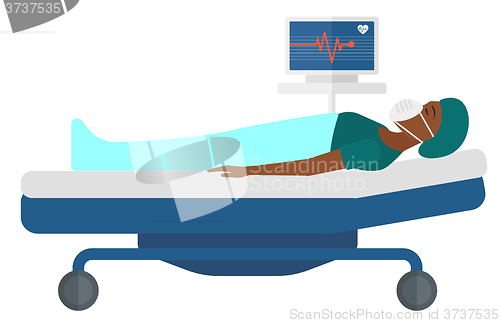 Image of Patient lying in bed with heart monitor.