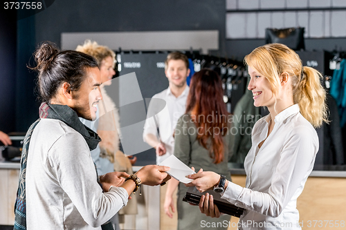 Image of Friends With Envelop By Bag Deposit Counter