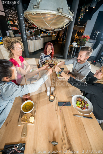 Image of Friends Toasting Wineglasses At Table