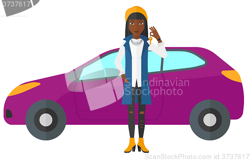 Image of Woman holding key from new car.