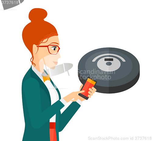 Image of Woman with robot vacuum cleaner.