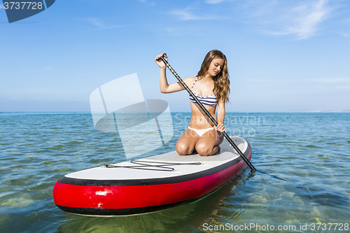 Image of Woman practicing paddle