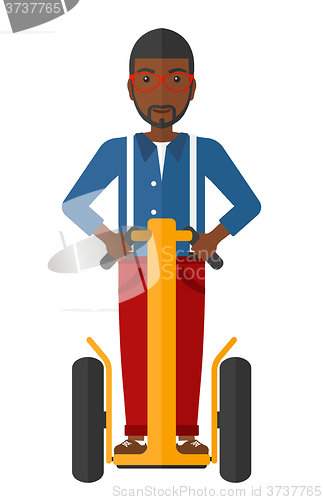 Image of Man riding on segway.