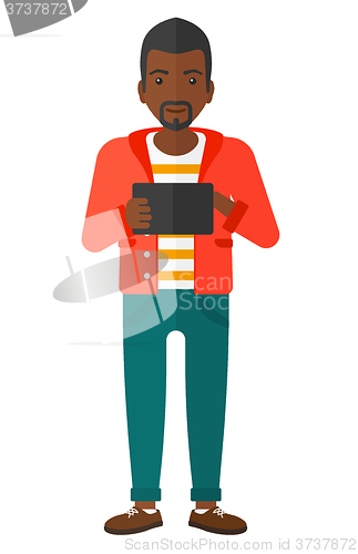 Image of Man using tablet computer.