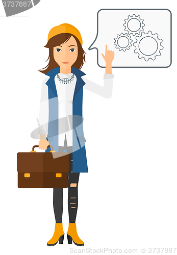 Image of Business woman pointing at cogwheels.