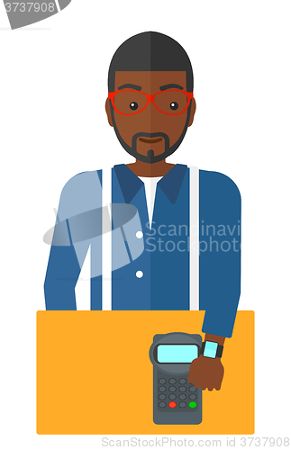 Image of Man paying with smart watch.