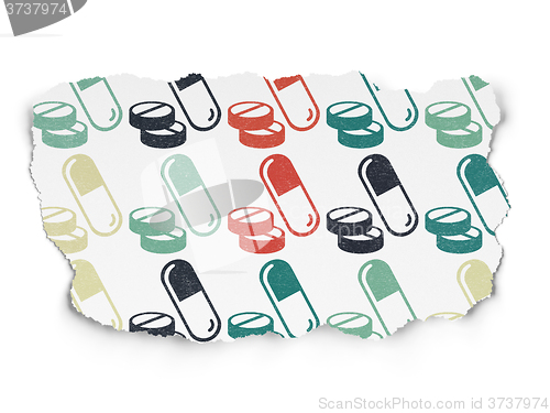 Image of Medicine concept: Pills icons on Torn Paper background