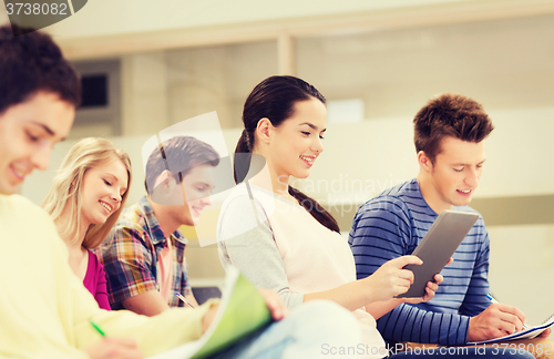 Image of group of smiling students with tablet pc