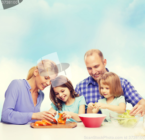 Image of happy family with two kids making dinner at home