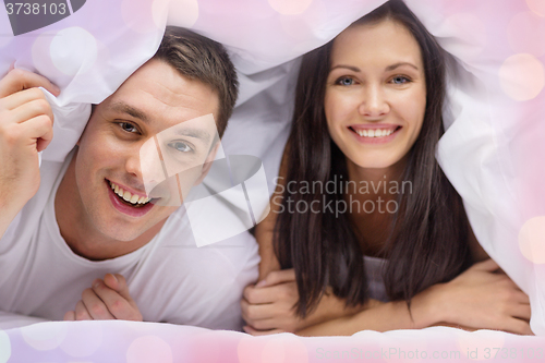 Image of happy couple sleeping in bed