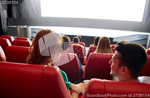 Image of happy couple watching movie in theater or cinema