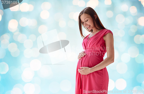 Image of happy pregnant woman with big tummy