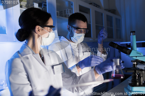 Image of close up of scientists making test in lab