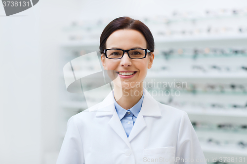 Image of woman optician in glasses and coat at optics store