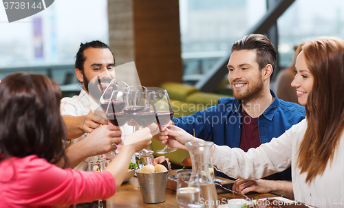 Image of friends dining and drinking wine at restaurant