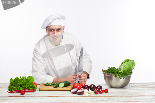 Image of Chef posing with knife in his kitchen