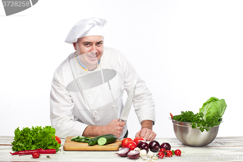 Image of Chef posing with knife in his kitchen