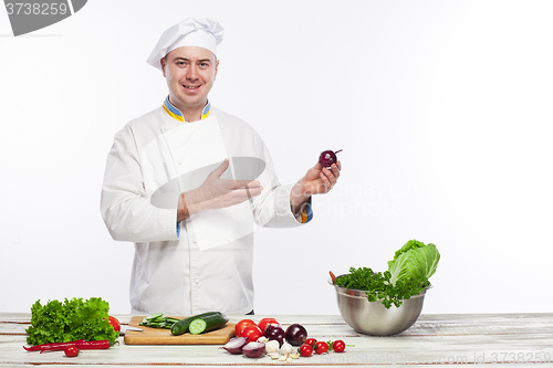 Image of Chef cooking fresh vegetable salad in his kitchen