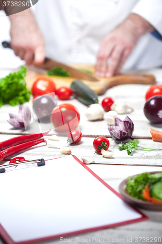 Image of Chef cutting a green parsley his kitchen