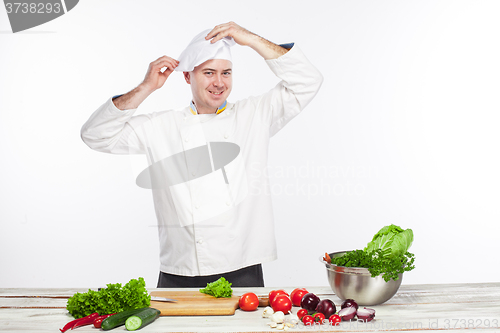 Image of Chef cooking fresh vegetable salad in his kitchen