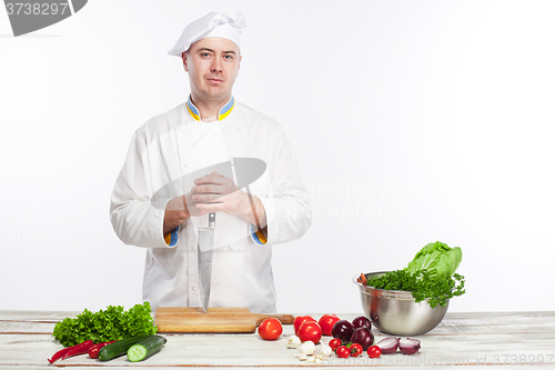 Image of Chef posing with knife in his kitchen
