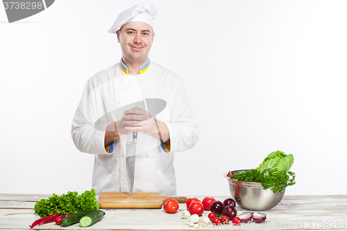 Image of Chef posing with knife in his kitchen