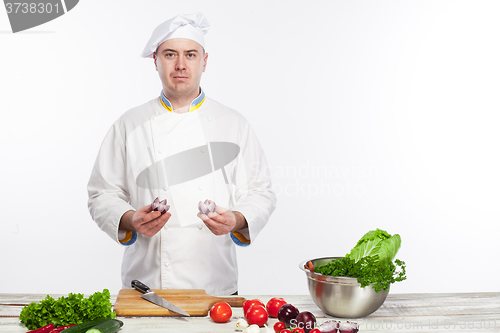 Image of Chef cooking fresh vegetable salad in his kitchen