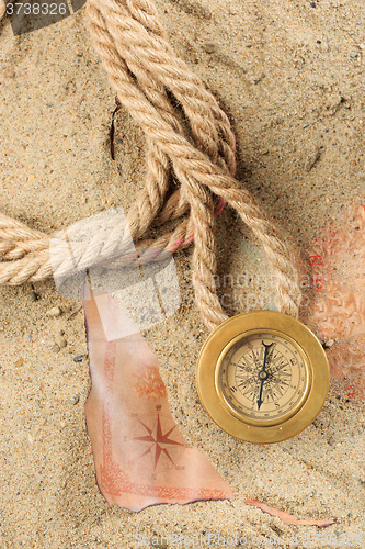 Image of set of nautical instruments, lying on the sand and old map. concept adventure