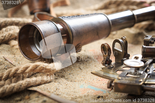 Image of set of nautical instruments, lying on the sand and old map. concept adventure