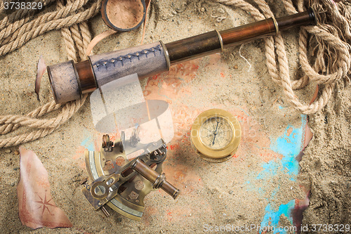 Image of set of nautical instruments, lying on the sand and old map. concept adventure